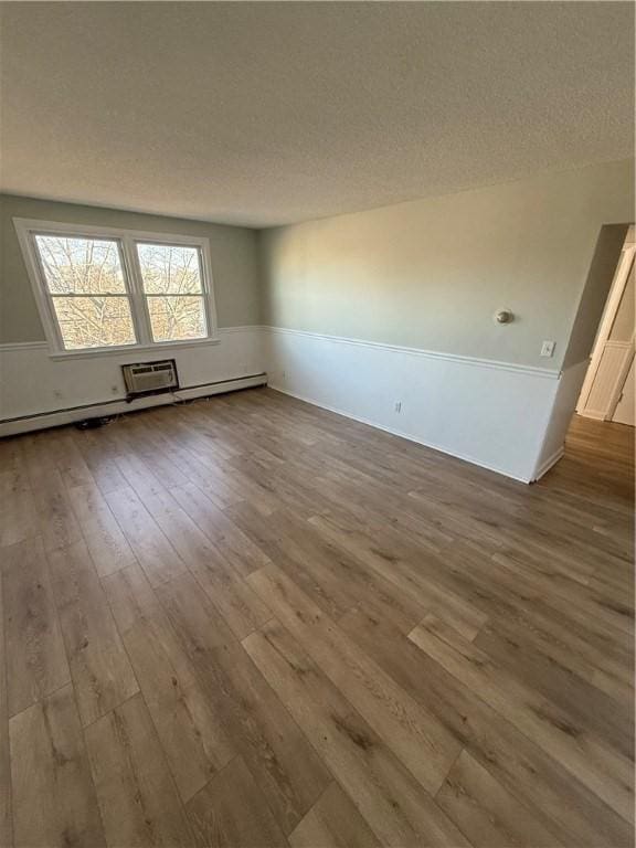 spare room with wood-type flooring and a textured ceiling