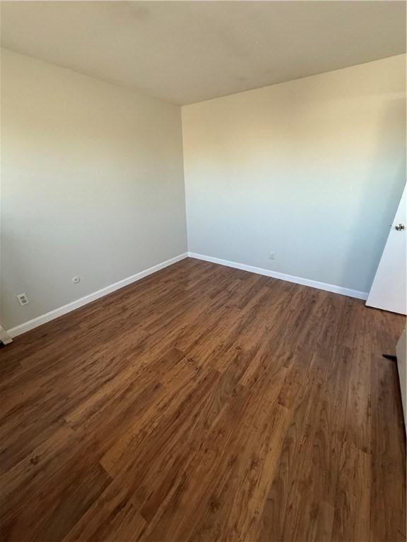 unfurnished room featuring dark hardwood / wood-style flooring