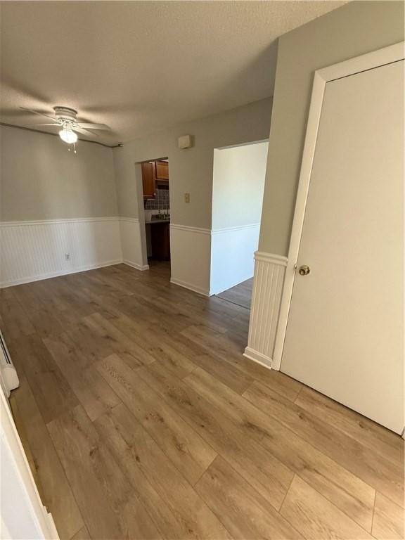 spare room featuring ceiling fan and light hardwood / wood-style flooring