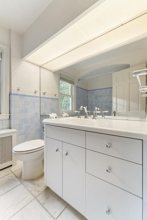 9 Dennison Rd, Worcester, MA 01609 - bathroom featuring vanity, toilet, tile walls, and radiator