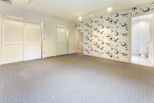 9 Dennison Rd, Worcester, MA 01609 - unfurnished bedroom featuring wallpapered walls, multiple closets, rail lighting, carpet floors, and ensuite bath