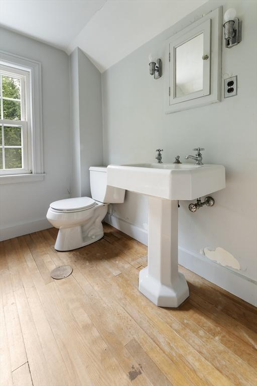 9 Dennison Rd, Worcester, MA 01609 - half bathroom featuring lofted ceiling, toilet, hardwood / wood-style floors, and baseboards