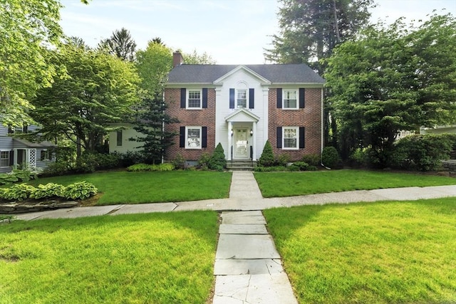 9 Dennison Rd, Worcester, MA 01609 - view of front of property with a front lawn, brick siding, and a chimney