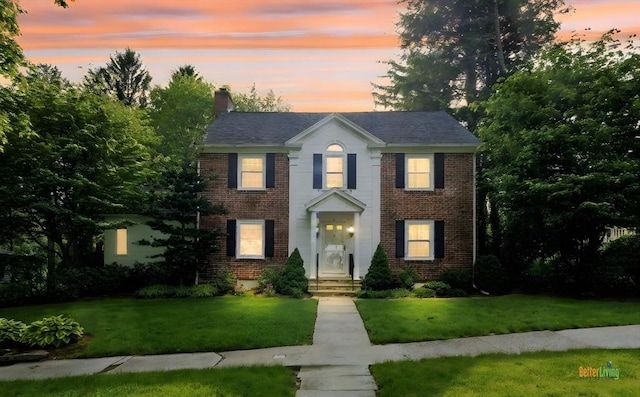 9 Dennison Rd, Worcester, MA 01609 - view of front of property with brick siding, a front yard, and a chimney