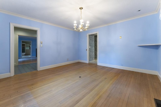 9 Dennison Rd, Worcester, MA 01609 - empty room with a chandelier, hardwood / wood-style flooring, crown molding, and baseboards