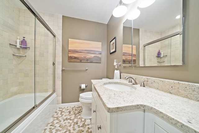 160 Pine St Unit 10, Newton, MA 02466 - bathroom featuring vanity, toilet, shower / bath combination with glass door, and baseboards