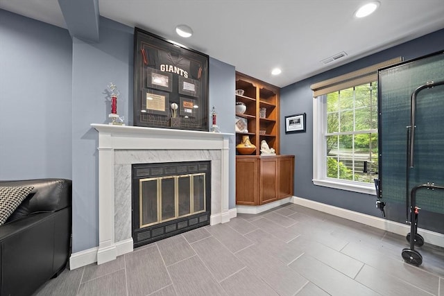 160 Pine St Unit 10, Newton, MA 02466 - unfurnished living room with baseboards, a high end fireplace, and recessed lighting