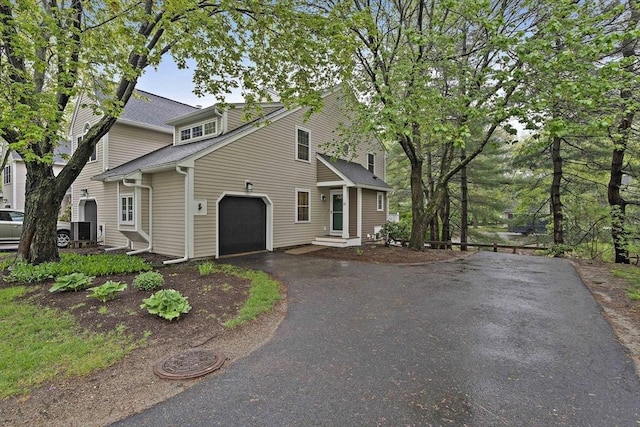 160 Pine St Unit 10, Newton, MA 02466 - view of side of home with driveway, a garage, and a shingled roof