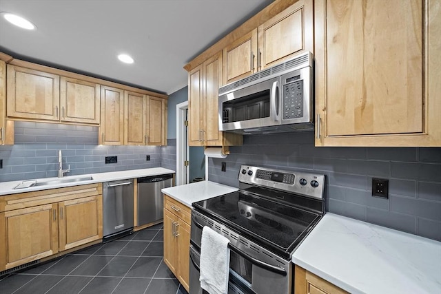 160 Pine St Unit 10, Newton, MA 02466 - kitchen featuring appliances with stainless steel finishes, a sink, dark tile patterned flooring, tasteful backsplash, and recessed lighting