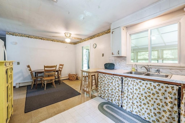 121 E St, Southampton, MA 01073 - kitchen with light countertops, a ceiling fan, light tile patterned floors, backsplash, and white cabinetry