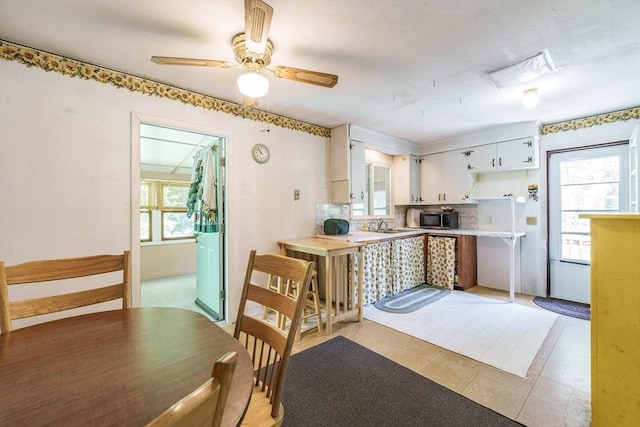 121 E St, Southampton, MA 01073 - kitchen with stainless steel microwave, white cabinets, plenty of natural light, and ceiling fan