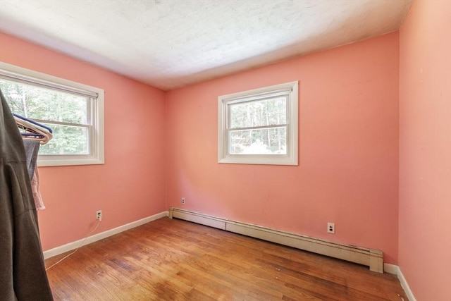 121 E St, Southampton, MA 01073 - spare room featuring baseboard heating, plenty of natural light, and light wood-style flooring