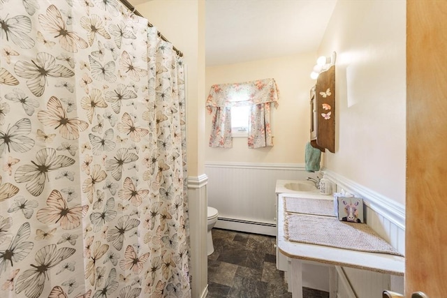121 E St, Southampton, MA 01073 - bathroom with baseboard heating, wainscoting, vanity, a shower with curtain, and stone finish floors