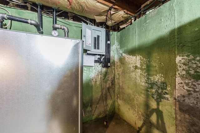 121 E St, Southampton, MA 01073 - unfinished below grade area with electric panel and freestanding refrigerator