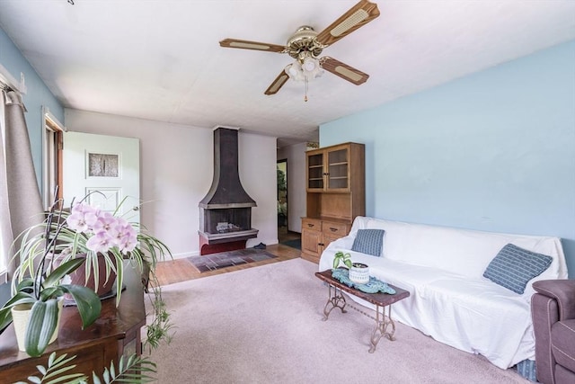 121 E St, Southampton, MA 01073 - living room featuring a ceiling fan, a wood stove, and wood finished floors