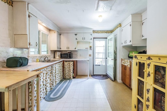 121 E St, Southampton, MA 01073 - kitchen with tasteful backsplash, white cabinets, light countertops, and stainless steel microwave