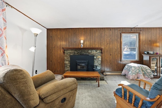 sitting room featuring wood walls, carpet, and a baseboard radiator