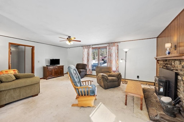 living area with light carpet and ceiling fan