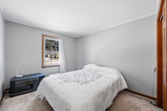 carpeted bedroom featuring baseboards