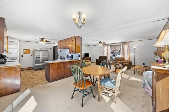 dining area with ceiling fan with notable chandelier