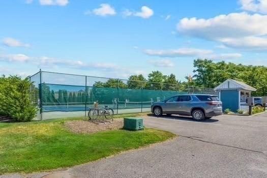 22 Grey Hawk Dr Unit 22, Mashpee, MA 02649 - exterior space with a tennis court and fence