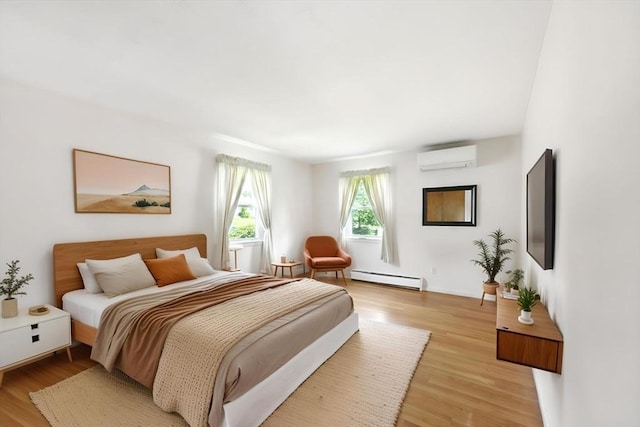25 Saybrook Cir, South Hadley, MA 01075 - bedroom with a wall mounted air conditioner, baseboard heating, light wood-type flooring, and baseboards