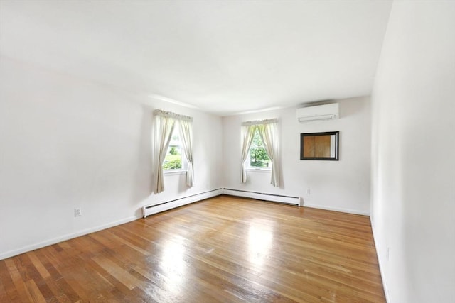 25 Saybrook Cir, South Hadley, MA 01075 - spare room with a wall mounted AC, wood finished floors, baseboards, and baseboard heating