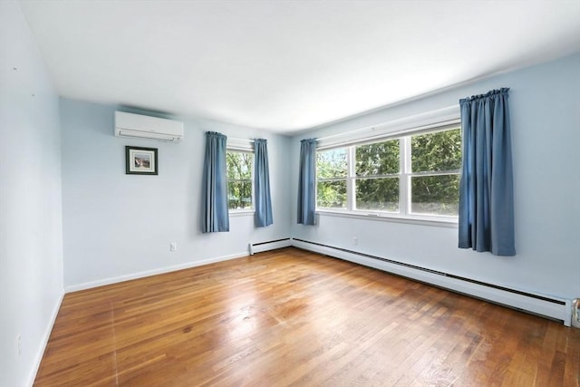 25 Saybrook Cir, South Hadley, MA 01075 - unfurnished room with a wall mounted air conditioner, a baseboard radiator, wood finished floors, and baseboards