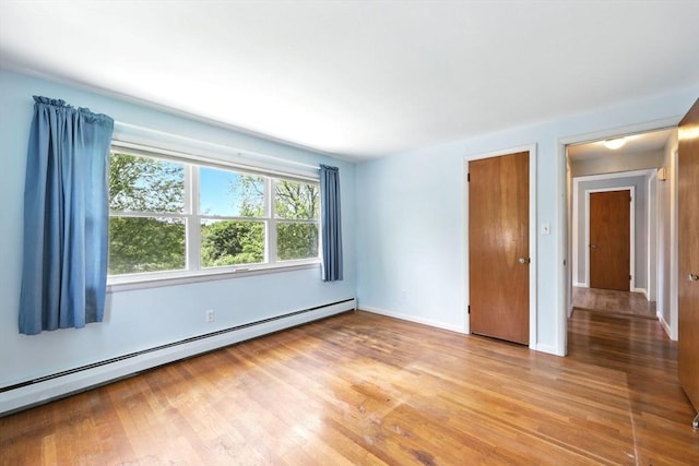 25 Saybrook Cir, South Hadley, MA 01075 - spare room with baseboard heating, light wood finished floors, and baseboards