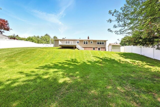 25 Saybrook Cir, South Hadley, MA 01075 - back of property featuring a deck, stairs, and a chimney