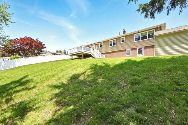 25 Saybrook Cir, South Hadley, MA 01075 - back of property featuring stairs, a deck, and a chimney