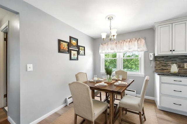 25 Saybrook Cir, South Hadley, MA 01075 - dining room featuring light wood-style flooring, a baseboard heating unit, and a chandelier