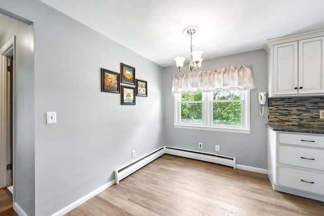 25 Saybrook Cir, South Hadley, MA 01075 - unfurnished dining area featuring a chandelier, baseboard heating, light wood-style flooring, and baseboards
