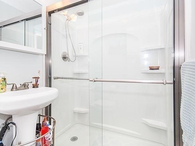 bathroom with a shower with door