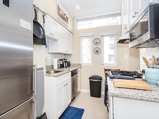 kitchen with appliances with stainless steel finishes, white cabinets, and decorative backsplash