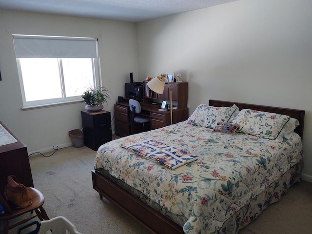 carpeted bedroom featuring baseboards