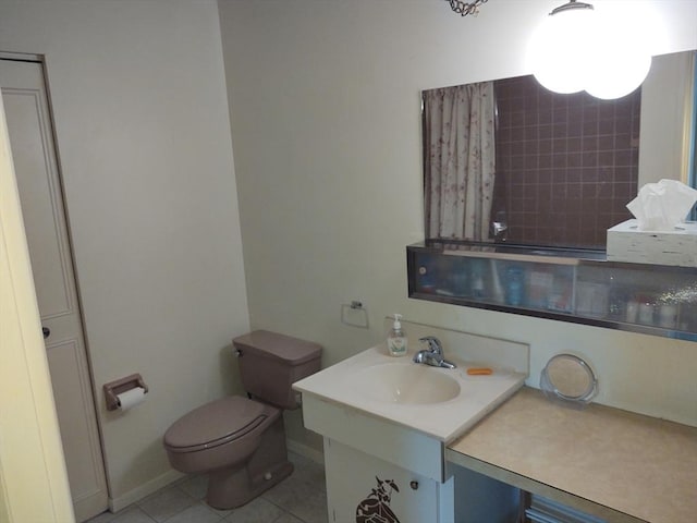 bathroom featuring vanity, toilet, and tile patterned floors