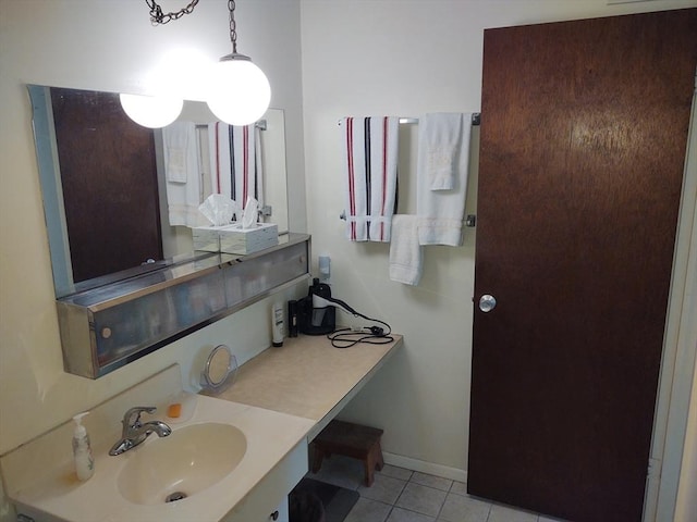 bathroom featuring baseboards, vanity, and tile patterned floors