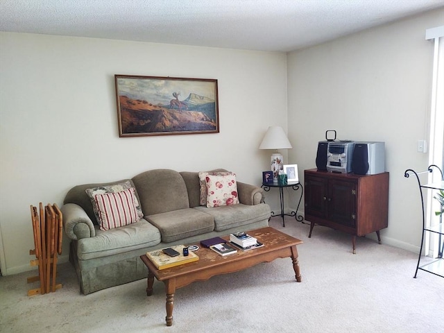 living room with carpet flooring, a textured ceiling, and baseboards