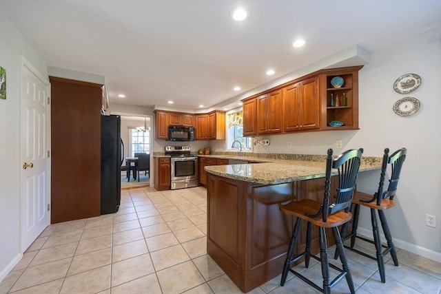 67 Jacap Dr, North Attleboro, MA 02760 - kitchen featuring black appliances, a peninsula, brown cabinets, recessed lighting, and light stone counters
