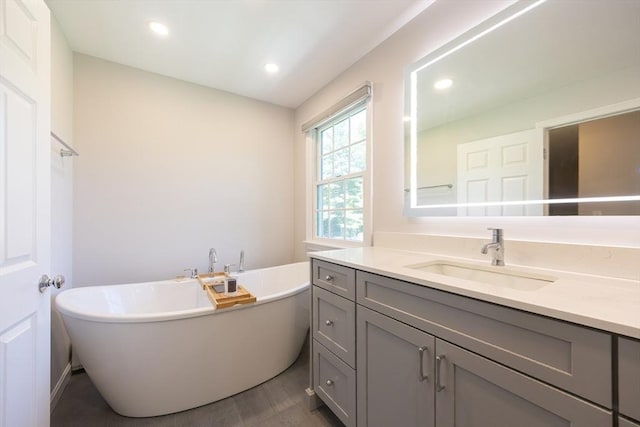 67 Jacap Dr, North Attleboro, MA 02760 - full bath featuring vanity, a freestanding bath, recessed lighting, and wood finished floors