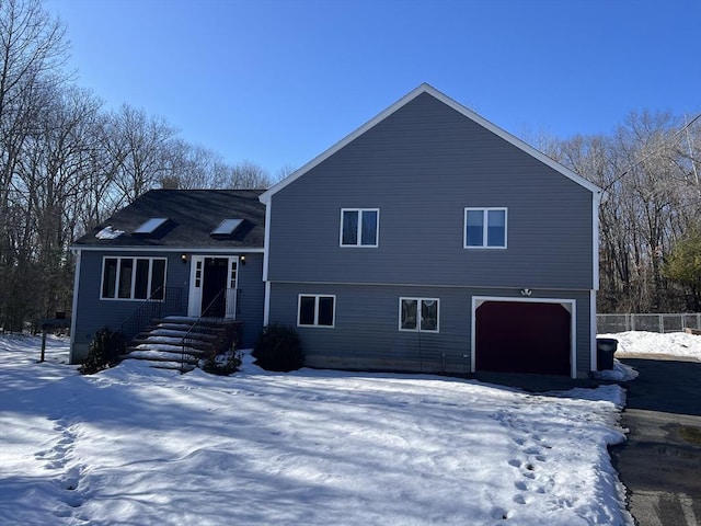 view of front of home with an attached garage and fence