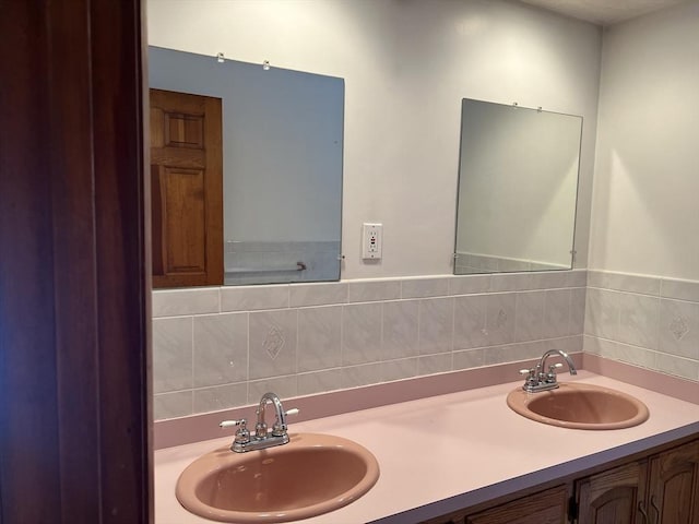 bathroom featuring a sink and double vanity