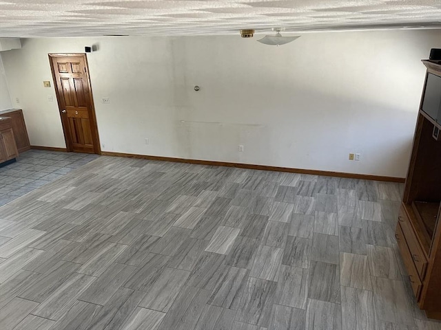 interior space with baseboards and wood tiled floor