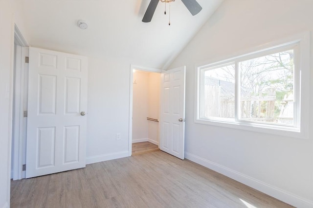 9 Bells Neck Rd Unit 4, Harwich, MA 02671 - unfurnished bedroom with vaulted ceiling, ceiling fan, baseboards, and wood finished floors