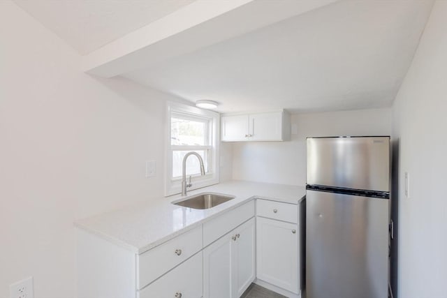 9 Bells Neck Rd Unit 4, Harwich, MA 02671 - kitchen with freestanding refrigerator, white cabinets, and a sink