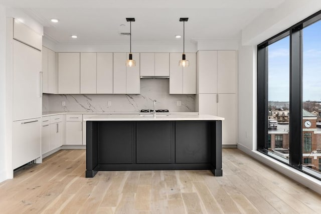 kitchen with white cabinetry, light countertops, modern cabinets, and tasteful backsplash