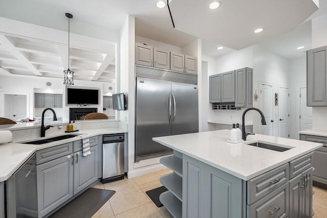 31 Cedar St, North Reading, MA 01864 - kitchen with gray cabinets, appliances with stainless steel finishes, a center island with sink, coffered ceiling, and beamed ceiling