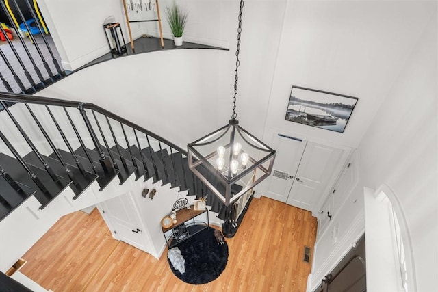 31 Cedar St, North Reading, MA 01864 - stairs featuring wood finished floors, a chandelier, and a towering ceiling
