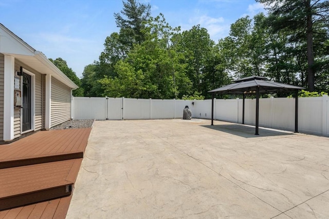 31 Cedar St, North Reading, MA 01864 - wooden terrace featuring a patio area, a gazebo, a fenced backyard, and a gate